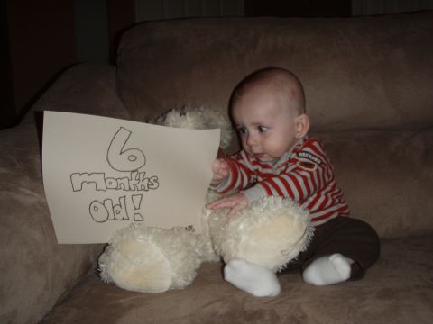 1997 Ford F-250 - A baby is shown with a sign indicating they are six months old.
