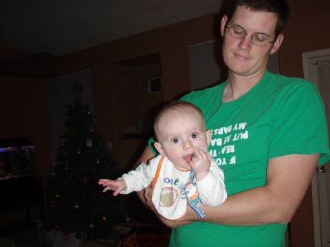 1997 Ford F-250 - A man holds a baby in front of a decorated Christmas tree.