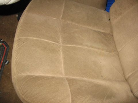 1987 Ford Bronco - Close-up view of a tan fabric seat interior, showing the stitching and texture of the upholstery.