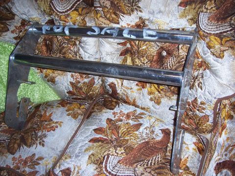 1979 Ford Bronco - Chrome bull bar with "FOR SALE" written on it, displayed on a patterned fabric.