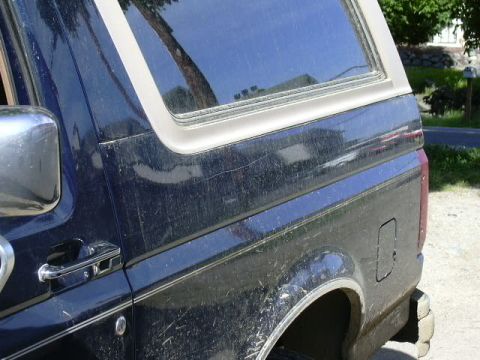 1991 Ford Bronco - Side view of a 1991 Ford Bronco, highlighting its body lines and rear quarter panel.