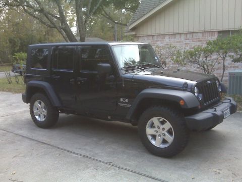 2008 Jeep Wrangler - This Jeep Wrangler is parked in front of a house.