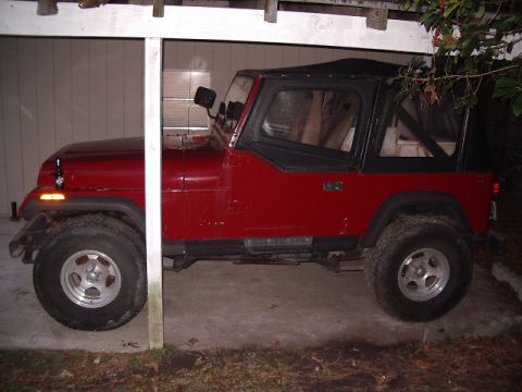 1987 Jeep YJ - This red Jeep Wrangler appears to be a 1987 model based on its body style.