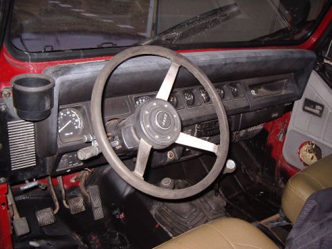1987 Jeep YJ - Interior view of a 1987 Jeep YJ, the dashboard, steering wheel, and pedals.