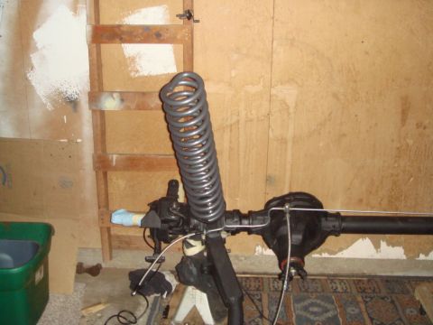 1992 Ford Bronco - Front axle assembly with coil spring, likely for an off-road vehicle modification.