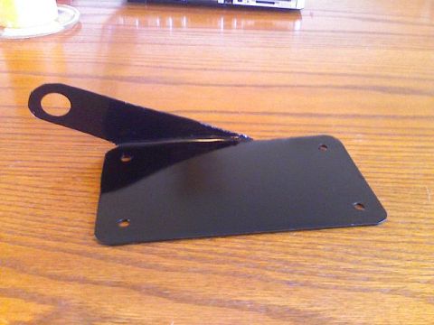 2008 Kawasaki Ninja R - A black metal bracket, likely a license plate holder, is shown on a wooden table.