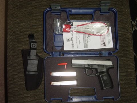 1992 Ford Bronco - A Smith & Wesson Sigma pistol is shown in its blue carrying case with accessories and documentation.