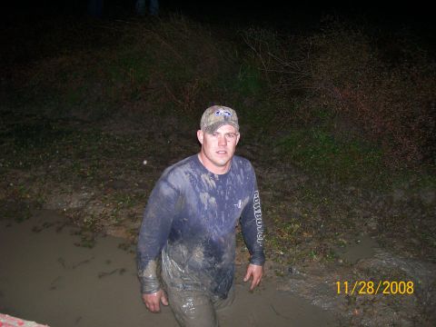 1988 Ford Bronco - Man covered in mud stands in a muddy area. Date stamp shows 11/28/2008.