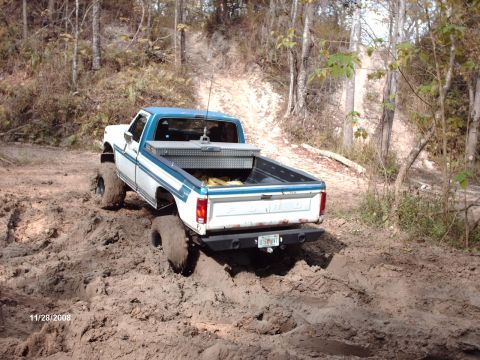 1982 Ford F-100 - This lifted 1980 Ford F-100 navigates a muddy off-road course, its off-road capabilities.