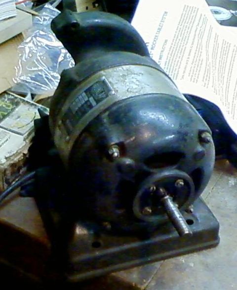 1995 Ford Bronco - An old electric motor sits on a surface, with instructions visible behind it.