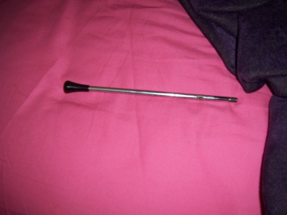 Chrome shift lever with black knob on pink fabric