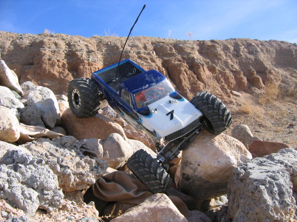 RC crawler truck with number 7 on hood climbing rocks
