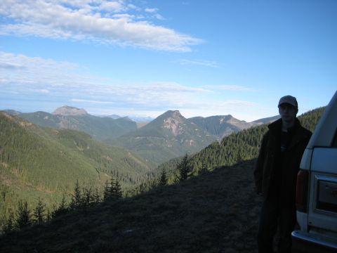 1980 Ford Bronco - A man stands by a 1980 Ford Bronco overlooking a vast mountain range.