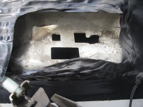 1995 Ford Bronco - Close-up view of a metal panel with several openings, possibly from a vehicle's interior.