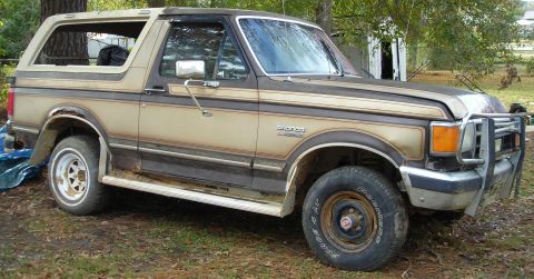 1988 Ford Bronco - This 1988 Ford Bronco features a two-tone paint scheme and a prominent brush guard on the front bumper.