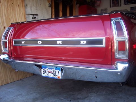 1972 Ford Ranchero - The rear of a red 1972 Ford Ranchero shows the tailgate with 'FORD' lettering and a chrome bumper.
