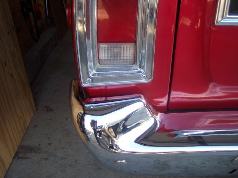 1972 Ford Ranchero - Close-up of the rear bumper and taillight assembly on a red 1972 Ford Ranchero.