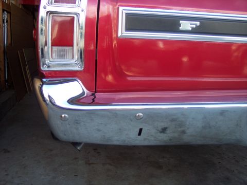 1972 Ford Ranchero - Rear view of a red 1972 Ford Ranchero showing the bumper and taillight assembly.