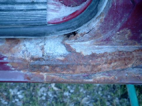 1990 Ford Bronco - Significant rust damage is visible on the door sill of this 1990 Ford Bronco.