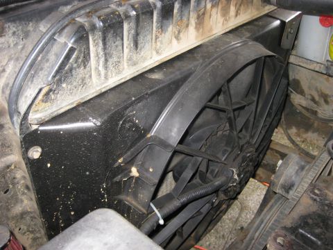 1979 Ford Bronco - Close-up view of an electric fan and its shroud, likely part of a vehicle's cooling system.