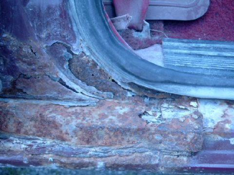 1990 Ford Bronco - Severe rust damage on the rocker panel of a vehicle, indicating a major problem area.