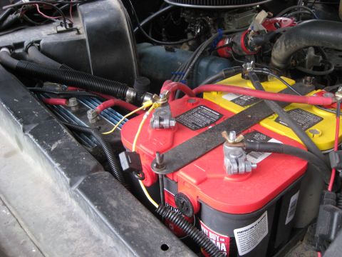 1979 Ford Bronco - Dual battery setup in an engine bay, red and yellow Optima batteries.