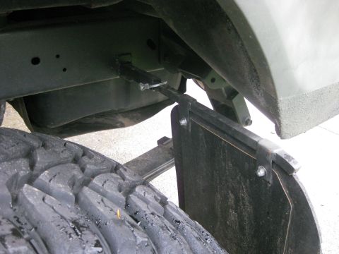 1979 Ford Bronco - Close-up view of a mud flap and tire on a vehicle.