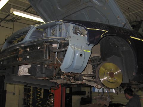2001 Ford Crown Victoria - Front end of a 2001 Ford Crown Victoria disassembled for repair, revealing suspension components.