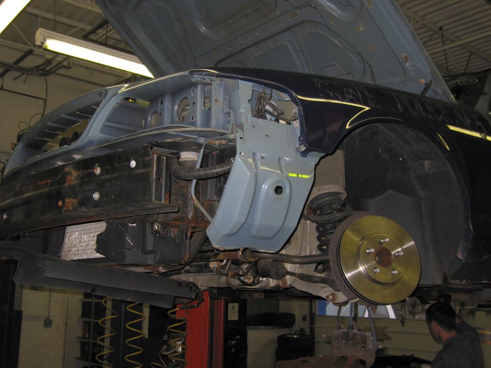 2001 Ford Crown Victoria front fender removed, showing suspension and brake rotor