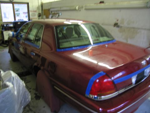 2001 Ford Crown Victoria - Red 2001 Ford Crown Victoria in a garage, prepped for paintwork with blue masking tape applied.