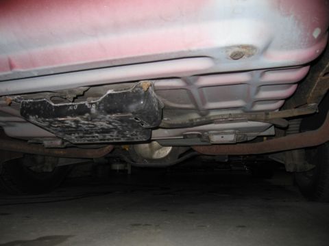 2001 Ford Crown Victoria - The undercarriage of a vehicle is visible, including the fuel tank and exhaust system.