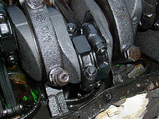 Engine crankshaft and connecting rods with oil pan visible