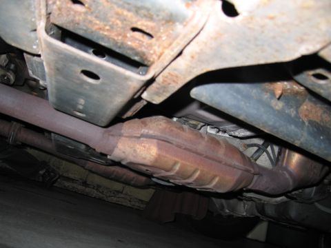 2001 Ford Crown Victoria - The undercarriage of a vehicle, focusing on the exhaust system and frame components.