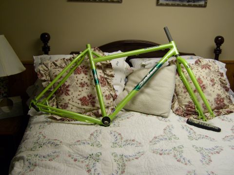 1972 Ford Ranchero - A bicycle frame is displayed on a bed, with pillows and a remote control nearby.