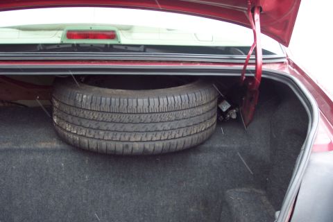 2001 Ford Crown Victoria - Spare tire located in the trunk of a vehicle.