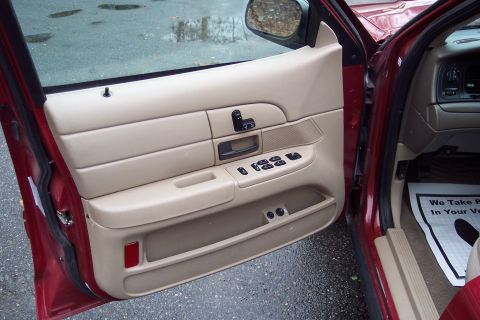 2001 Ford Crown Victoria - Interior view of a 2001 Ford Crown Victoria, showing the driver's side door panel and controls.