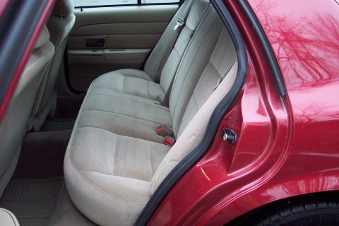 2001 Ford Crown Victoria - Rear interior view of a 2001 Ford Crown Victoria, showing the seats and door.