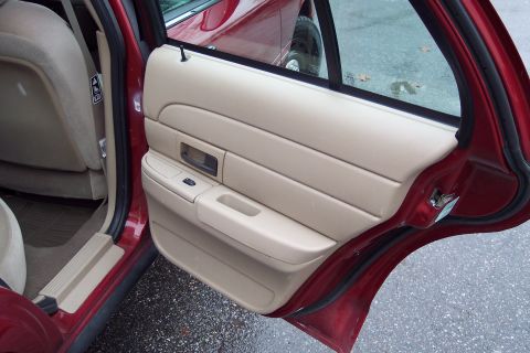 2001 Ford Crown Victoria - Interior view of a 2001 Ford Crown Victoria, focusing on the tan door panel and seat.