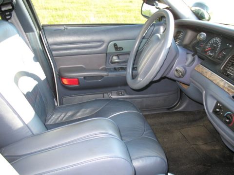 2000 Ford Crown Victoria - The interior of a Ford Crown Victoria is shown, leather seats and the dashboard area.