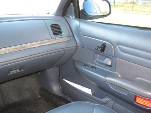 2000 Ford Crown Victoria - Interior view of a 2000 Ford Crown Victoria, highlighting the dashboard and door panel details.