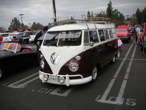 1998 Ford Crown Victoria - A classic Volkswagen bus is parked at an outdoor event with other vehicles visible in the background.
