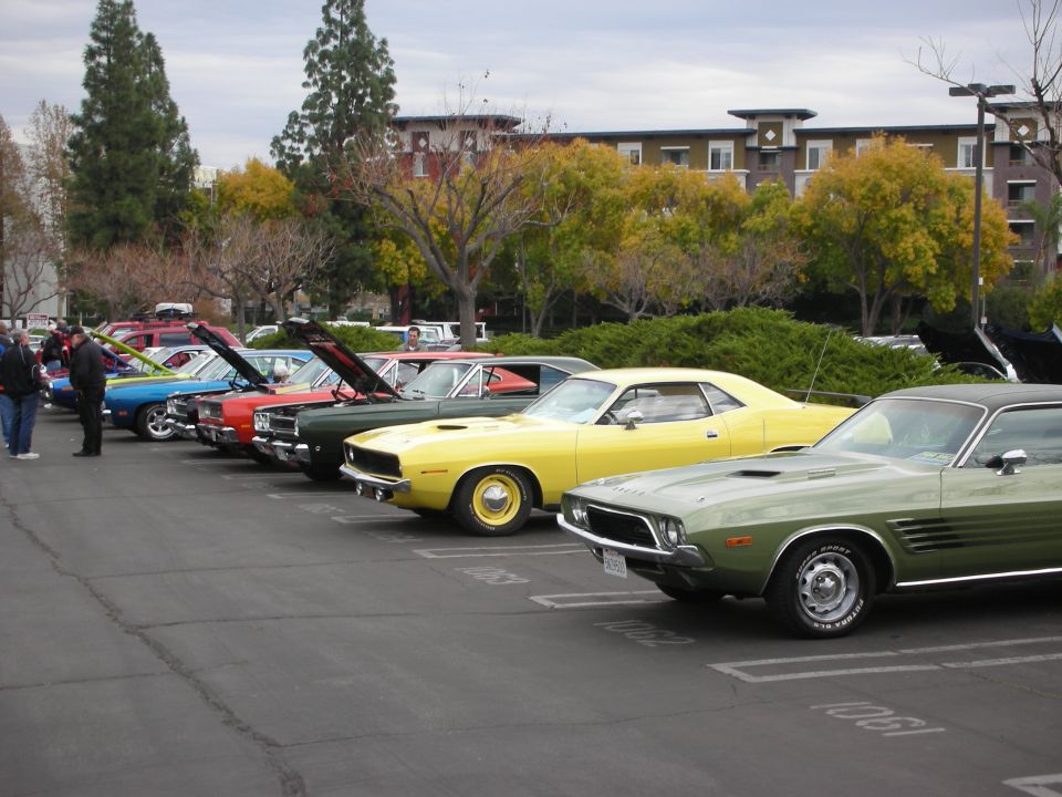 Green 1970 Dodge Challenger parked in a lot, front 3/4 view
