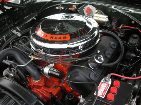1998 Ford Crown Victoria - Close-up of a vehicle's engine compartment, a prominent chrome air cleaner and orange engine block.