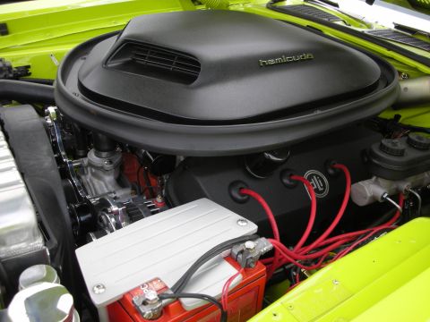 1998 Ford Crown Victoria - Close-up of a vehicle's engine bay, highlighting the Hemi 'cuda air intake and bright red spark plug wires.