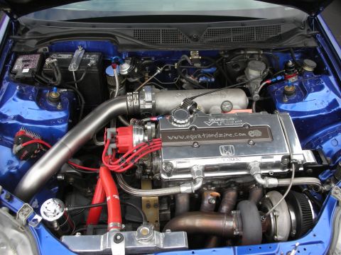 1998 Ford Crown Victoria - Customized engine bay a VTEC engine with turbocharger and prominent "www.equationdzine.com" branding.