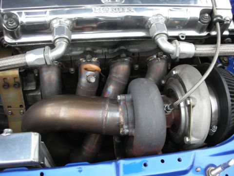 1998 Ford Crown Victoria - Custom turbo setup on a Honda engine, a polished valve cover and aftermarket exhaust components.