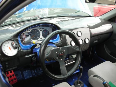 1998 Ford Crown Victoria - Customized car interior with racing-style steering wheel and gauges.