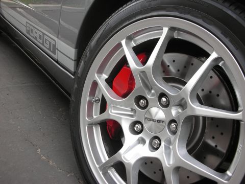 1998 Ford Crown Victoria - The wheel and side stripe of a Ford GT are visible in this close-up shot.