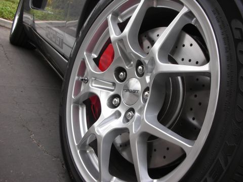 1998 Ford Crown Victoria - Close-up of a vehicle's wheel, showing "FORD GT" branding on the center cap and a side stripe.