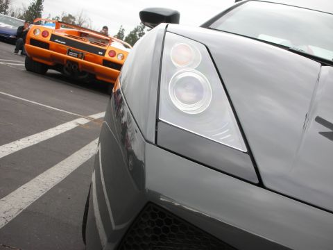 1998 Ford Crown Victoria - Photograph of a Lamborghini Gallardo front end with a McLaren F1 in the background.
